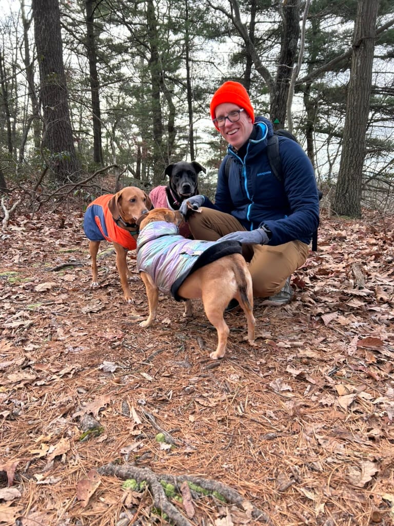 Zelda and I with her two best friends Freyja and Loki. She is the hound dog on the left in the orange jacket. I am the human